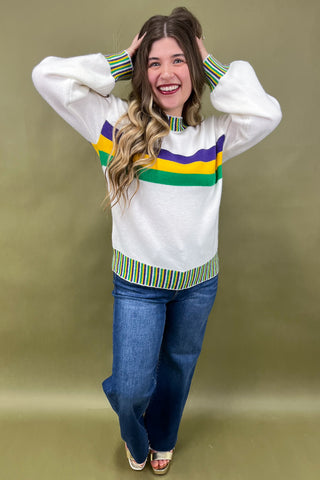 Woman wearing a colorful sweater with a green background
