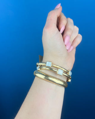 Shop the Alyssa Matte Gold Bracelet Set featuring three coordinating matte gold bangles with elegant white stone accents for effortless everyday style.