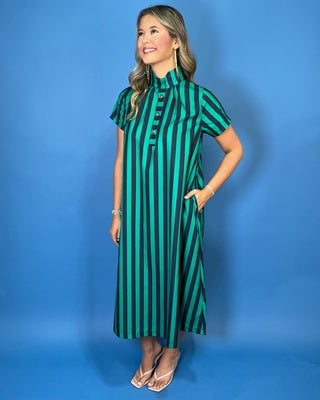 Emerald green and navy striped satin midi dress with high neckline, short sleeves, and statement button detail.