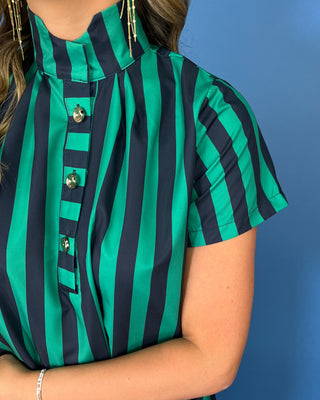 Emerald green and navy striped satin midi dress with high neckline, short sleeves, and statement button detail.