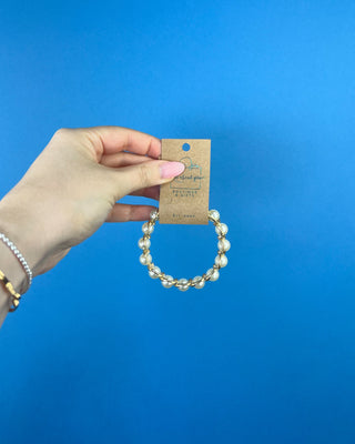Shop the Pearl Bracelet featuring elegant white faux pearls in polished gold-tone settings with a comfortable stretch fit for timeless style.