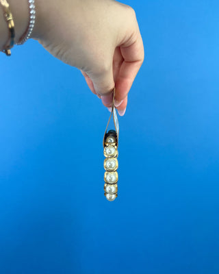 Shop the Pearl Bracelet featuring elegant white faux pearls in polished gold-tone settings with a comfortable stretch fit for timeless style.