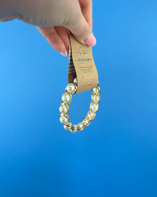 Shop the Pearl Bracelet featuring elegant white faux pearls in polished gold-tone settings with a comfortable stretch fit for timeless style.