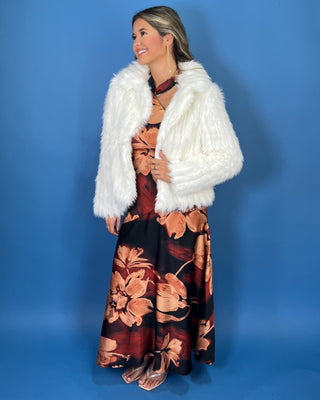 Ivory faux fur cropped jacket with plush textured fabric, long sleeves, open front, and oversized collar.