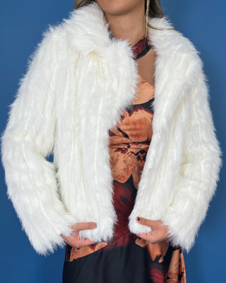 Ivory faux fur cropped jacket with plush textured fabric, long sleeves, open front, and oversized collar.