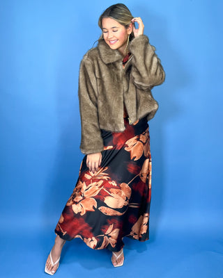 Taupe faux fur cropped jacket with plush texture, oversized collar, long sleeves, and front zipper closure.