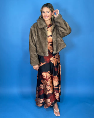 Taupe faux fur cropped jacket with plush texture, oversized collar, long sleeves, and front zipper closure.