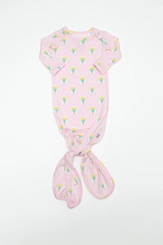 Pink baby swaddle with floral pattern on a white background
