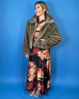 Taupe faux fur cropped jacket with plush texture, oversized collar, long sleeves, and front zipper closure.