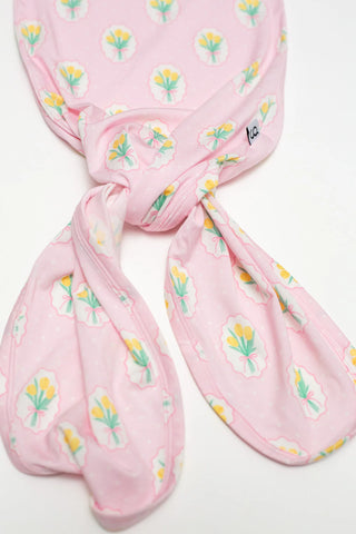 Pink floral-patterned headscarf on a white background