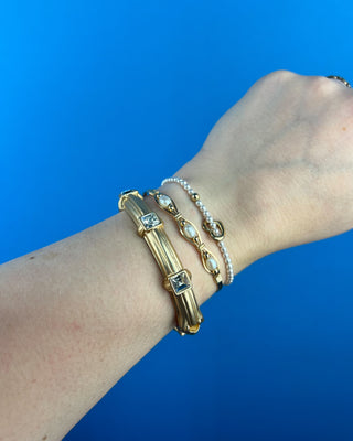 Shop the Grace Gold Hinged with Square Crystals Bracelet featuring a polished gold finish and sparkling square crystals for timeless everyday elegance.