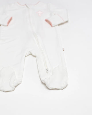White baby onesie with pink accents on a white background