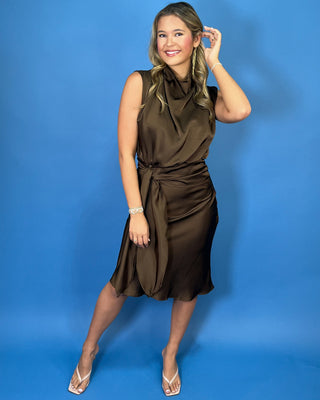 Chocolate brown satin midi dress with a draped cowl neckline, sleeveless design, and flattering tie-waist detail.