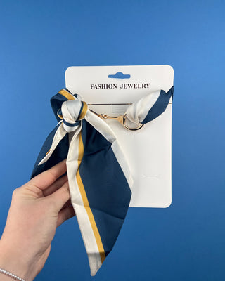 Shop the Horse Bit Scarf Necklace featuring elegant gold-tone hardware and a silky satin scarf. Available in multiple colors and stylish prints.
