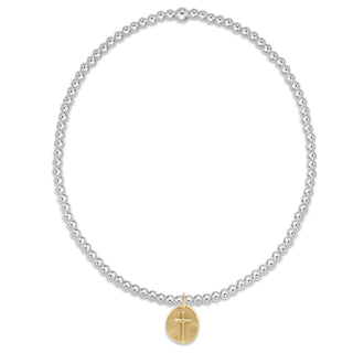 Pearl necklace with a gold cross pendant on a white background