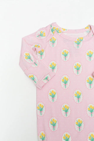 Pink baby onesie with floral pattern on a white background