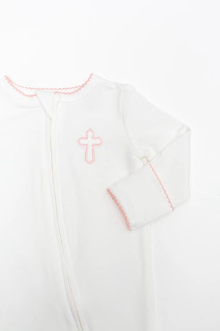 White baby outfit with pink cross design on a white background