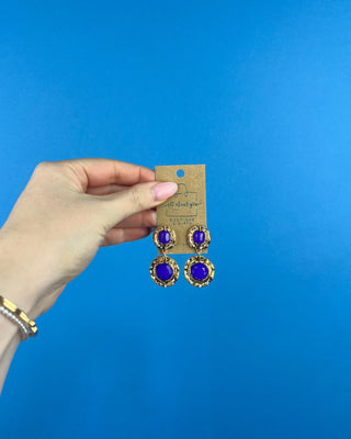Shop the Lauren Gold & Purple Earrings featuring vibrant purple stones, textured gold-tone details, and a bold double-drop design perfect for LSU game day.