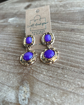 Shop the Lauren Gold & Purple Earrings featuring vibrant purple stones, textured gold-tone details, and a bold double-drop design perfect for LSU game day.