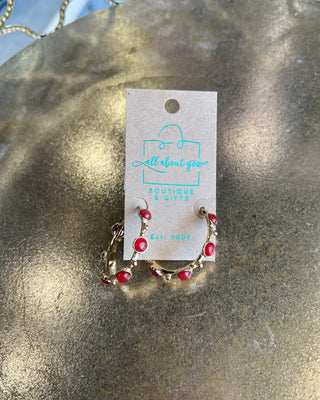 Shop the Rachel Red Stone Hoops featuring glossy red stones, polished gold-tone hoops, and delicate bead accents. Perfect for holidays and game days.