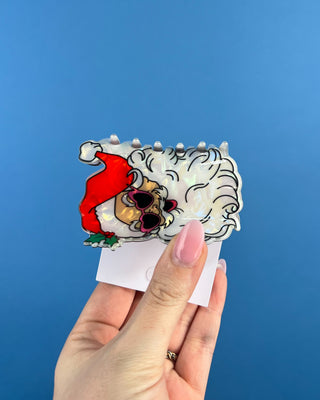 Shop the Santa Hair Clip featuring a pearlescent Santa design, pink heart sunglasses, and festive holiday details. A cute Christmas claw clip!