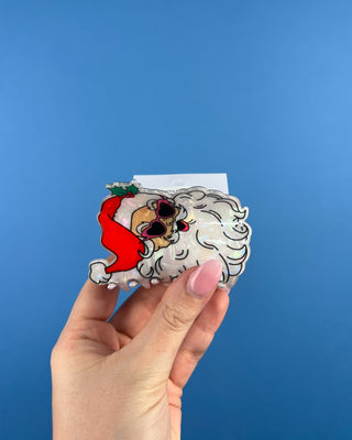 Shop the Santa Hair Clip featuring a pearlescent Santa design, pink heart sunglasses, and festive holiday details. A cute Christmas claw clip!