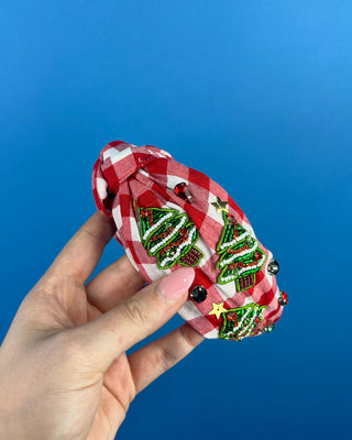 Shop the Red Gingham Christmas Headband featuring beaded Christmas trees, sparkling rhinestones, and a festive knotted design. Perfect for holiday outfits!