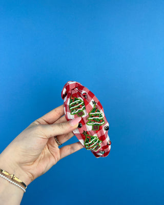 Shop the Red Gingham Christmas Headband featuring beaded Christmas trees, sparkling rhinestones, and a festive knotted design. Perfect for holiday outfits!