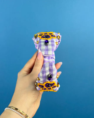 Shop the Purple Gingham Gameday Headband featuring sparkling purple and gold beaded paw prints, rhinestones, and a trendy knotted design. Perfect for game day!