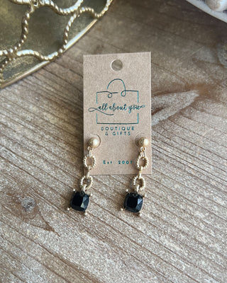 Shop the Adrian Black Stone Earrings featuring gold-tone textured links, polished ball studs, and faceted black square stones. Perfect for any occasion!