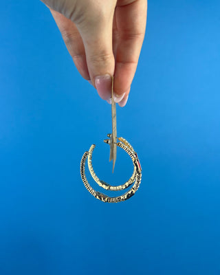 Shop the Gabi Red Stone Hoops featuring gold-tone hoops, sparkling clear rhinestones, and rich red rectangular stones. Perfect for holidays and everyday style!