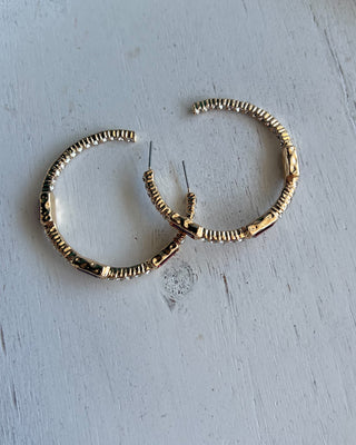 Shop the Gabi Red Stone Hoops featuring gold-tone hoops, sparkling clear rhinestones, and rich red rectangular stones. Perfect for holidays and everyday style!
