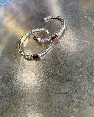 Shop the Gabi Red Stone Hoops featuring gold-tone hoops, sparkling clear rhinestones, and rich red rectangular stones. Perfect for holidays and everyday style!