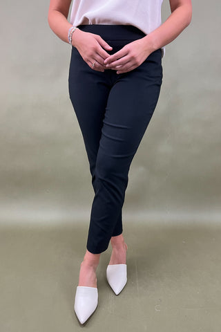 Person wearing black pants and white shoes on a plain background