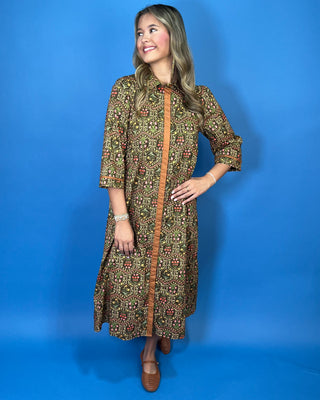 Olive floral print midi dress with contrast trim, three-quarter sleeves, button-front detail, and side pockets.