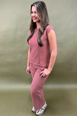 Woman wearing a red and white striped outfit on a green background