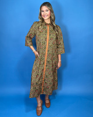 Olive floral print midi dress with contrast trim, three-quarter sleeves, button-front detail, and side pockets.