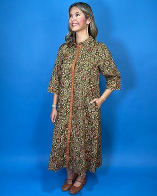 Olive floral print midi dress with contrast trim, three-quarter sleeves, button-front detail, and side pockets.