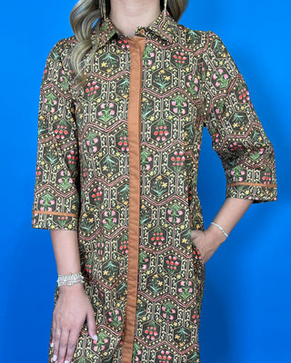 Olive floral print midi dress with contrast trim, three-quarter sleeves, button-front detail, and side pockets.