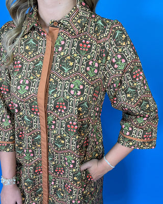Olive floral print midi dress with contrast trim, three-quarter sleeves, button-front detail, and side pockets.