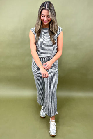 Woman wearing a striped outfit on a green background