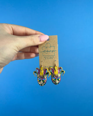 Shop the Jester Mardi Gras Earrings featuring glittery purple, green, and gold jester masks. Perfect for Mardi Gras parades, Fat Tuesday, and festive outfits.