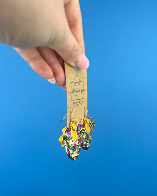 Shop the Jester Mardi Gras Earrings featuring glittery purple, green, and gold jester masks. Perfect for Mardi Gras parades, Fat Tuesday, and festive outfits.