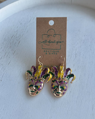 Shop the Jester Mardi Gras Earrings featuring glittery purple, green, and gold jester masks. Perfect for Mardi Gras parades, Fat Tuesday, and festive outfits.