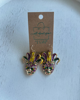 Shop the Jester Mardi Gras Earrings featuring glittery purple, green, and gold jester masks. Perfect for Mardi Gras parades, Fat Tuesday, and festive outfits.