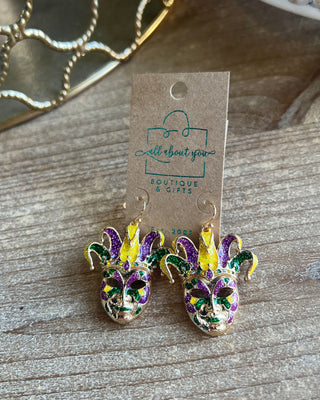 Shop the Jester Mardi Gras Earrings featuring glittery purple, green, and gold jester masks. Perfect for Mardi Gras parades, Fat Tuesday, and festive outfits.