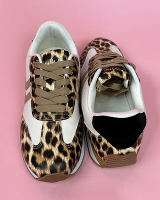 Leopard print sneakers on a pink background
