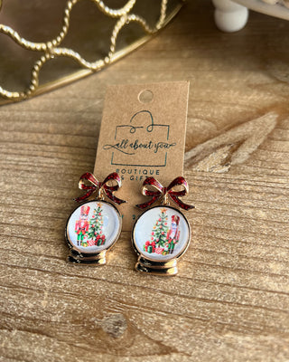 Shop the Christmas Nutcracker Snow Globe Bow Earrings at All About You Boutique! Festive red glitter bows and charming Christmas snow globe designs.