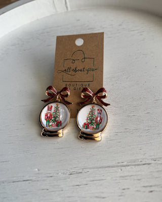 Shop the Christmas Nutcracker Snow Globe Bow Earrings at All About You Boutique! Festive red glitter bows and charming Christmas snow globe designs.