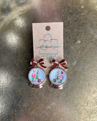 Shop the Christmas Nutcracker Snow Globe Bow Earrings at All About You Boutique! Festive red glitter bows and charming Christmas snow globe designs.